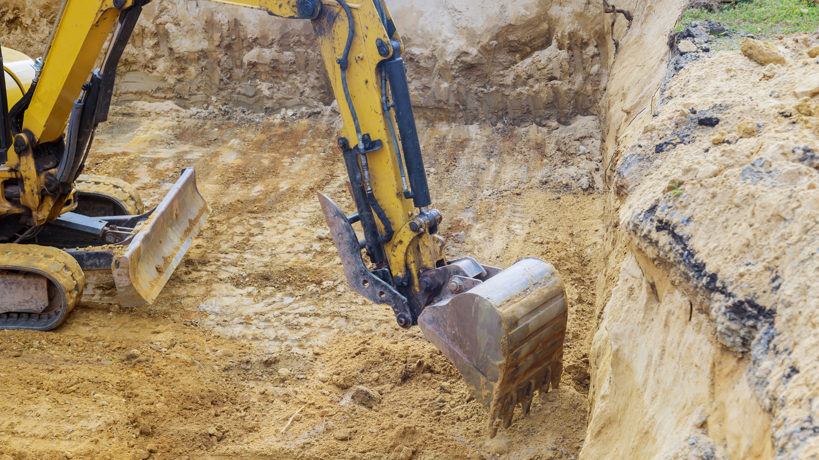 A bulldozer digging a hole in the ground