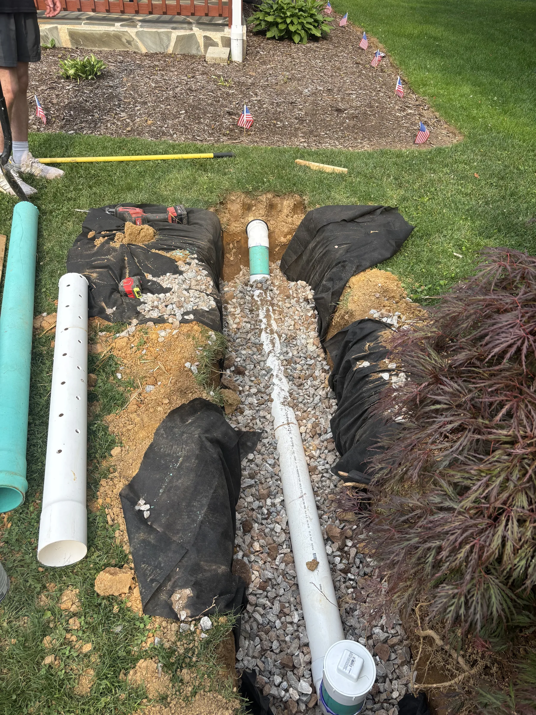 Overhead view of septic drainage piping and gravel bed during a residential install