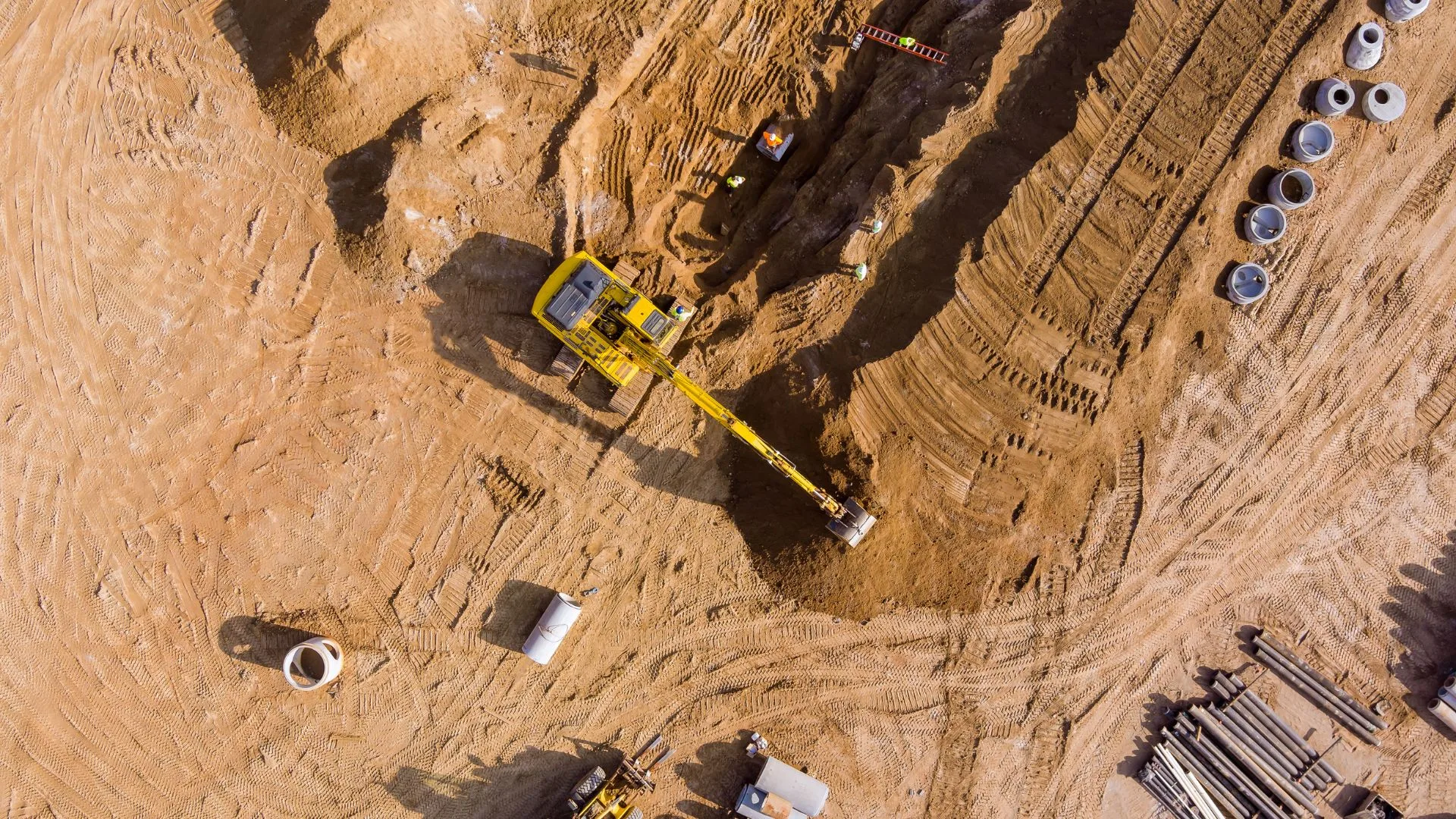 Aerial view of a sewer line trench crossing a construction site